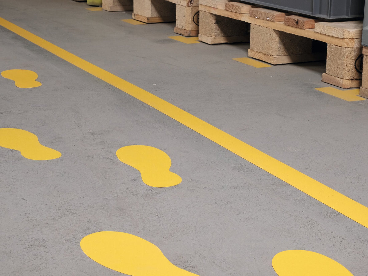 Yellow Durable footprints beside a yellow floor line in a warehouse