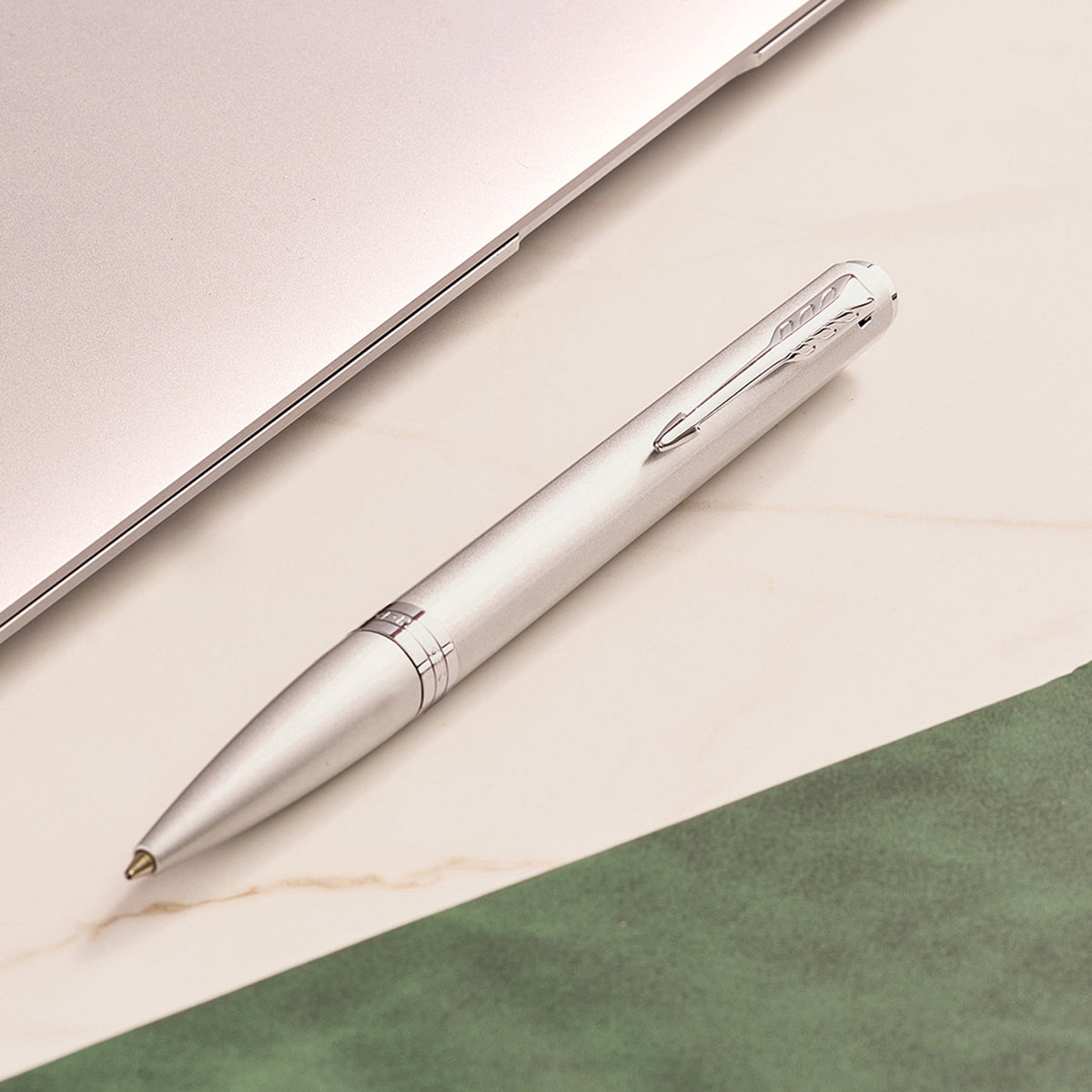 Chrome Meridian ballpoint in a styled desk setting, showing the chrome clip and centre band