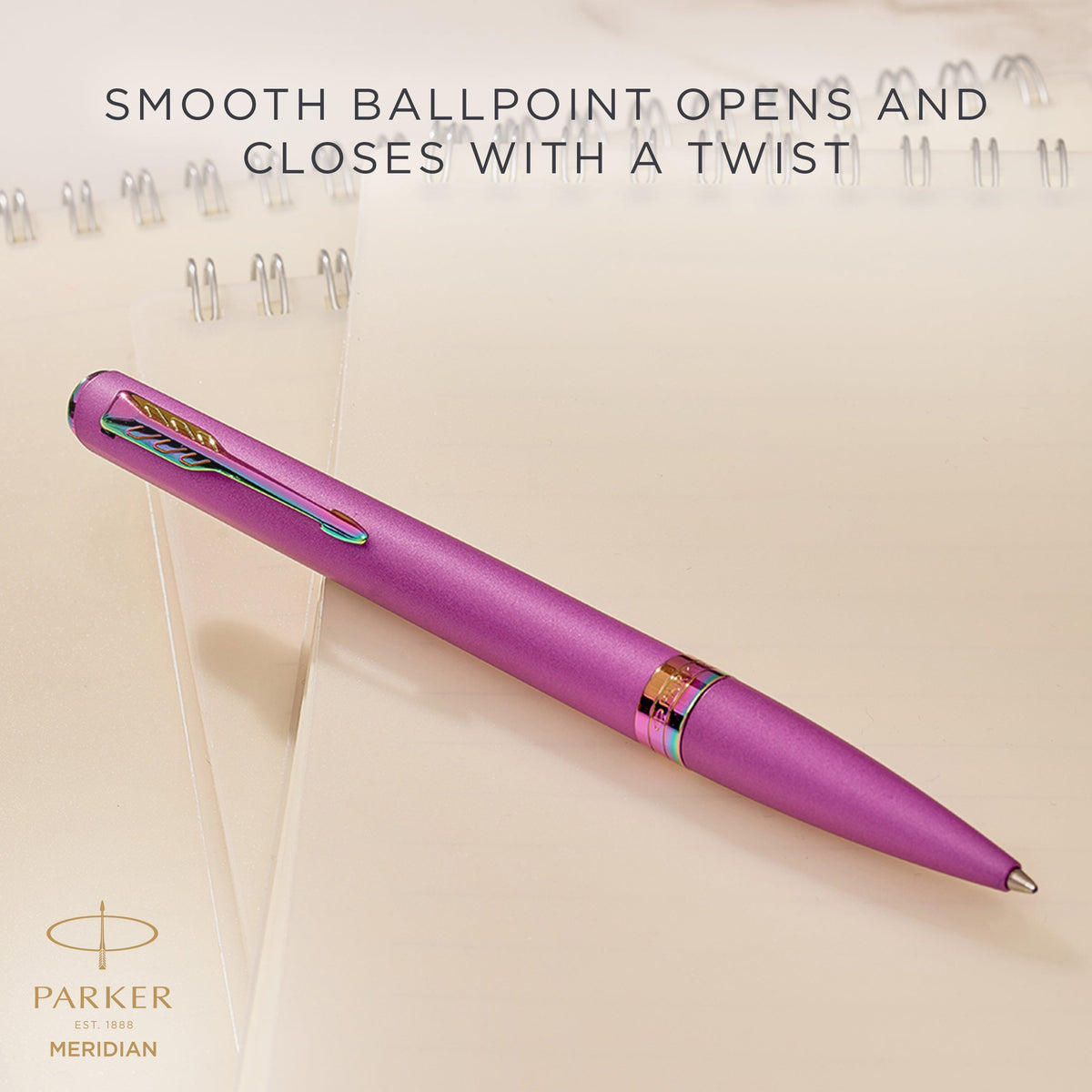 Grape Meridian ballpoint resting on a desk, with Parker's caption that the smooth ballpoint opens and closes with a twist
