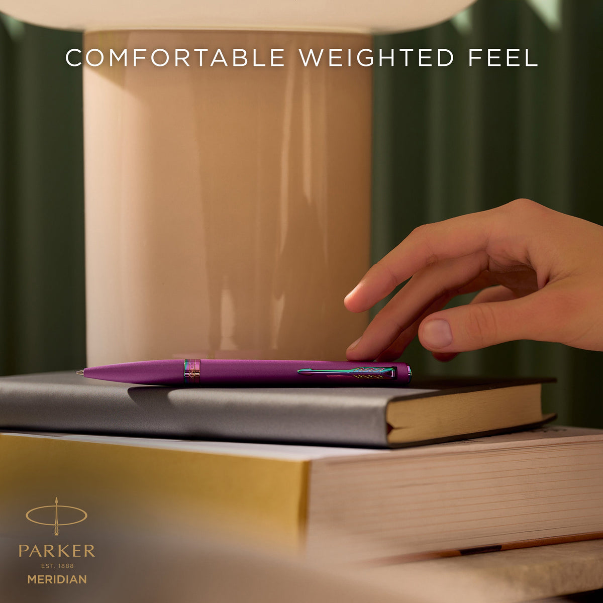 Hand writing with the grape Meridian ballpoint, captioned comfortable weighted feel