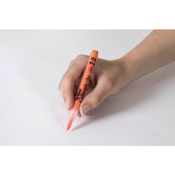 Hand writing with a pastel orange Artline Calligraphy Pen 2.0